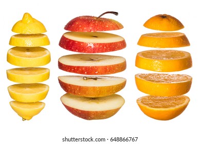 Creative Concept With  Flying Fruits. Sliced Orange, Lemon, Apple Isolated On White. Levity Fruit Floating In The Air.