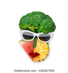 Creative concept photo of cubist style female face in sunglasses made of fruits and vegetables, on white background. - Powered by Shutterstock