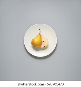 Creative concept photo of kitchenware, painted plate with food on it on grey background.