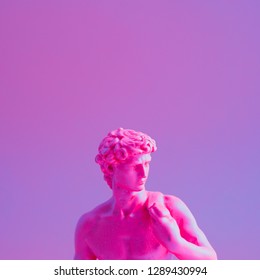 Creative concept of purple neon David is a masterpiece of Renaissance sculpture created  by Michelangelo. Vaporwave style  