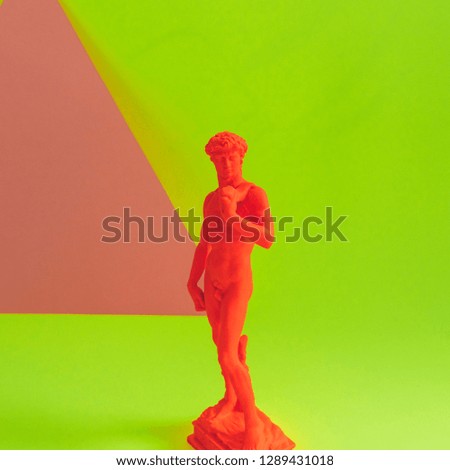 Creative concept of red neon David is a masterpiece of Renaissance sculpture created  by Michelangelo. Vaporwave style. Colorful background 