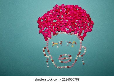 Creative Concept Silhouette Of A Man With A Turban And Earrings, A Face Made Of Decorative Sugar In The Shape Of A Heart And Stars And A Turban Made Of Pink Stones