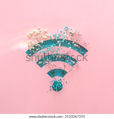 Creative concept of spring. Radio waves with flowers on a pink background.