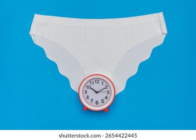 Creative Concept of Time Management: Clock and Panties Abstract Art on Blue Background