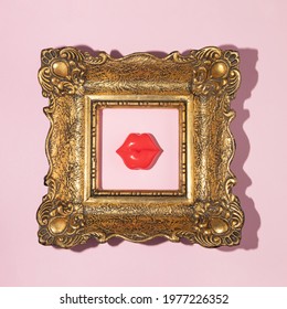 Creative Concept With Vintage Golden Painting Frame And Bright Red Lips On Pastel Pink Background. 80s Or 90s Romantic Summer Or Spring  Art Direction. Valentines Day Aesthetic Idea.