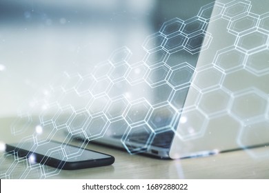 Creative concept of wireless technology with hexagon hologram on modern laptop background. Big data and database concept. Multiexposure