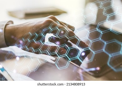 Creative concept of wireless technology with hexagon hologram and finger clicks on a digital tablet on background. Big data and database concept. Multiexposure