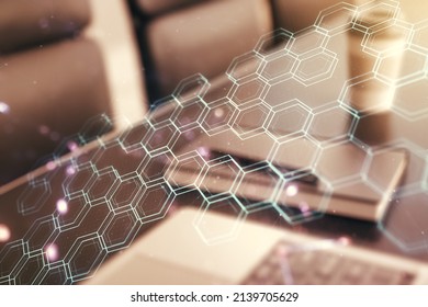 Creative concept of wireless technology with hexagon hologram on modern laptop background. Big data and database concept. Multiexposure