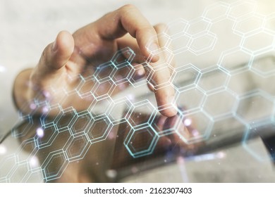 Creative concept of wireless technology with hexagon hologram and finger clicks on a digital tablet on background. Big data and database concept. Multiexposure