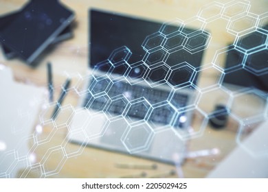 Creative concept of wireless technology with hexagon hologram on modern laptop background. Big data and database concept. Multiexposure
