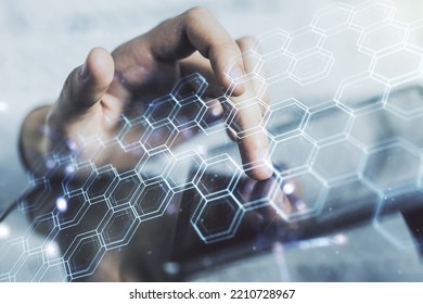 Creative concept of wireless technology with hexagon hologram and finger clicks on a digital tablet on background. Big data and database concept. Multiexposure