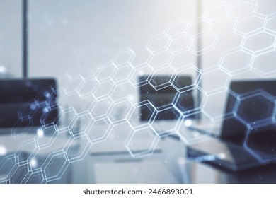 Creative concept of wireless technology with hexagon hologram and modern desktop with computer on background. Big data and database concept. Multiexposure