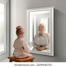 Creative conceptual collage. Little girl looking in mirror and seeing reflection of senior lady. Her future self. Child and grandmother. Concept of present, past and future, age, lifestyle, generation - Powered by Shutterstock