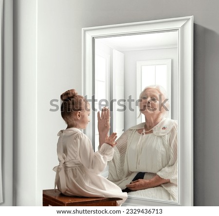 Creative conceptual collage. Little girl looking in mirror and seeing reflection of senior lady. Her future self. Child and grandmother. Concept of present, past and future, age, lifestyle, generation