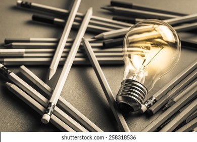 Creative Content  Writing, Light Bulb And Many Pencils On The Table