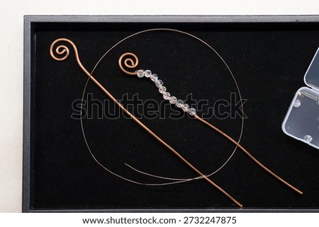 Creative craft project, working on a velvet tray, copper wire in two gages and clear crystal faceted beads, ready to get started

