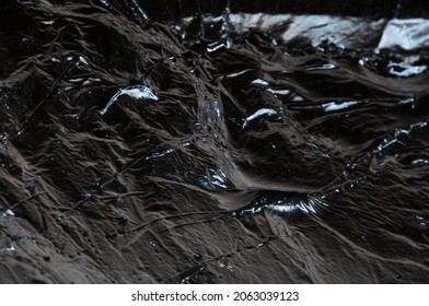 Creative Dark Background. Oil Production Concept. Crude Oil Close Up