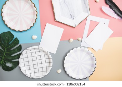 Creative decorated and arranged flat lay frame concept with blank card template and tropical palm leaf. Mock up workspace with top view.