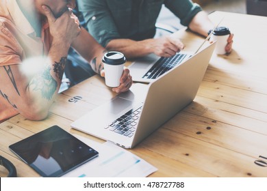 Creative Department Working Wood Table Laptop Modern Interior Design Loft.Coworkers Process Office Studio.Two Hipsters Use Contemporary Notebook Digital Devices.Blurred Background. Business Startup