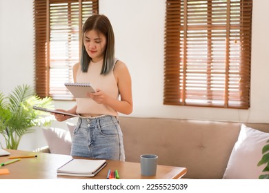 Creative design concept, Fashion designer looking on sketching of new collection clothes in notepad. - Shutterstock ID 2255525039