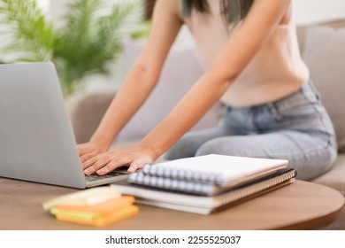Creative design concept, Female designer sitting on couch and working to contact client in laptop. - Shutterstock ID 2255525037