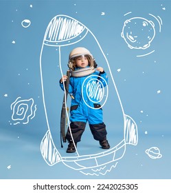 Creative design with drawn elements. Portrait of little boy, child in costume of astronaut over blue background. Flying on doodle racket. Concept of imagination, childhood, creativity, dreams, ad - Shutterstock ID 2242025305