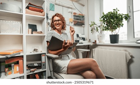 A Creative Designer seamstress working in an Artistic Workspace, actively engaged in the Crafting process. He holds a sketch in his hands. - Powered by Shutterstock