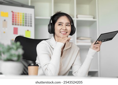 Creative Designer Working in Modern Office with Digital Tablet and Headphones - Powered by Shutterstock