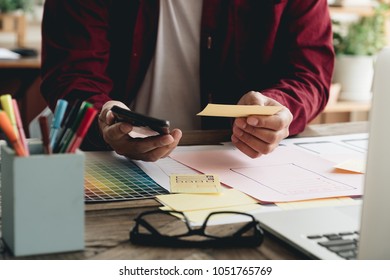 Creative designer working at office. Creating new mobile web design, Designer's desk with responsive web design concept.