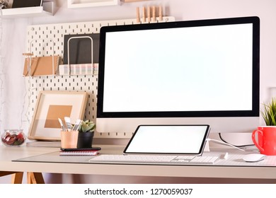 Creative designer workplace with desktop computer and drawing sketches tablet.