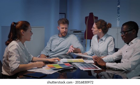 Creative designers discussing color tones at meeting in office. Multiethnic team of fashion stylist brainstorm and work on clothes collection in modern workspace - Powered by Shutterstock