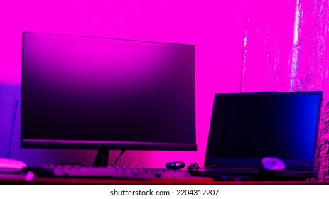 Creative Designer's Workplace, Back View. Office Chair And Work Desk View With Graphic Tablet, Computer And Smartphone. Retoucher Home Office In Neon Pink Blue