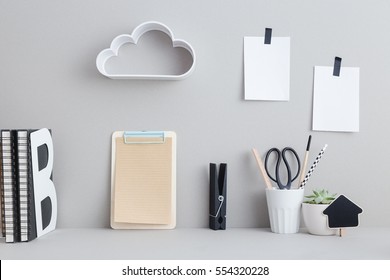 Creative Desk With Blank Picture Frame Or Poster, Desk Objects, Office Supplies, Books And Plant On A Gray Background. Creative Desk.