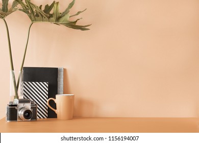 Creative desk with copy space. Empty pastel orange wall. Minimalistic concept of modern interior.. - Powered by Shutterstock