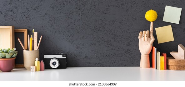 Creative Desk With Empty Space Notebook, School Objects, Office Supplies, Books, And Plant On A Dark Grey Background. 	