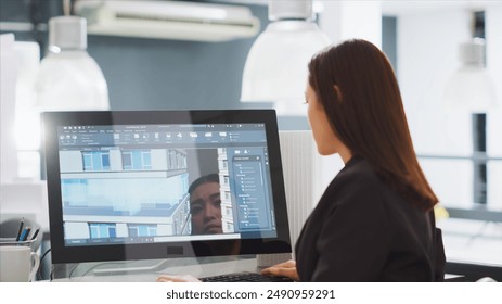 Creative developer designing building models on 3d software, working on creating construction layout at workstation. Woman undergoing architecture task with cad program, startup agency. - Powered by Shutterstock