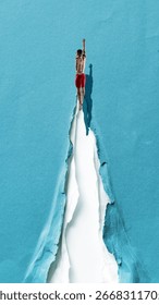 Creative digital artwork. Swimmer diving into torn paper path symbol of breakthrough and victory. Concept of sport energy, courage, success, resilience, challenge, freedom, strength and focus.