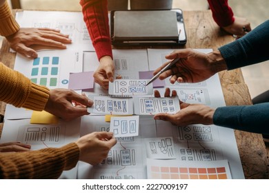 Creative digital development agency. developer team brainstorming on their project with laptop, smartphone and digital tablet.