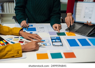 Creative digital development agency. developer team brainstorming on their project with laptop, smartphone and digital tablet.