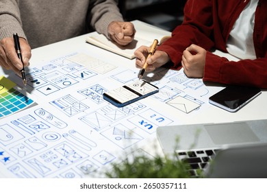 Creative digital development agency. developer team brainstorming on their project with laptop, smartphone and digital tablet.