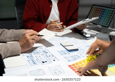 Creative digital development agency. developer team brainstorming on their project with laptop, smartphone and digital tablet.