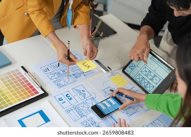 Creative digital development agency. developer team brainstorming on their project with laptop, smartphone and digital tablet.	