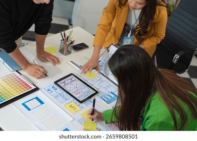 Creative digital development agency. developer team brainstorming on their project with laptop, smartphone and digital tablet.	