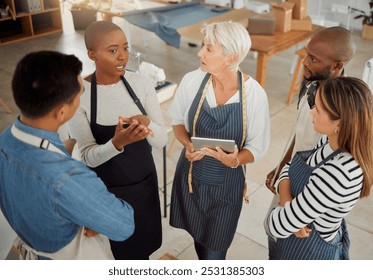 Creative, diverse and discussion for group, fashion designer and planning with tablet, talking and workshop. Tailor, teamwork and people in business meeting, apron and conversation in design studio - Powered by Shutterstock