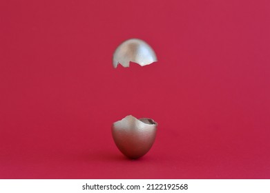 Creative Easter egg surprise concept. Golden easter egg broken in half on a red background, levitation. Copy space. - Powered by Shutterstock