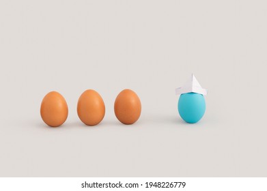
Creative Easter layout with raw eggs and blue egg wearing origami paper hat isolated on grey background