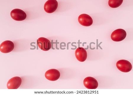 Creative Easter pattern composition made with red colored Easter eggs on light pink background. Minimal Easter concept. Spring holiday pattern background. Flay lay, top of view.