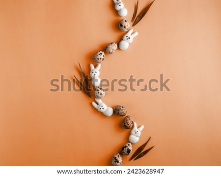 Creative Easter wave composition made from motley quail eggs, marshmallow bunny and grass on peach fuzz trend 2024 color background. Spring, easter concept. Flat lay, top view, copy space