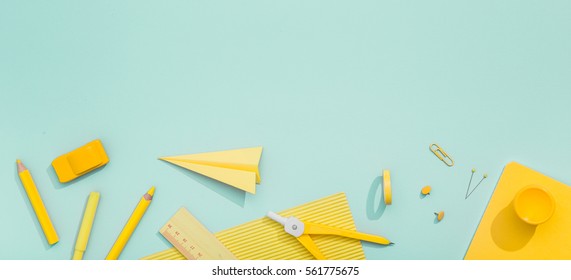 Creative, fashionable, minimalistic, school or office workspace with yellow supplies on cyan background. Flat lay. स्टॉक फ़ोटो
