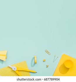 Creative, Fashionable, Minimalistic, School Or Office Workspace With Yellow Stationery On Cyan Background. Flat Lay.